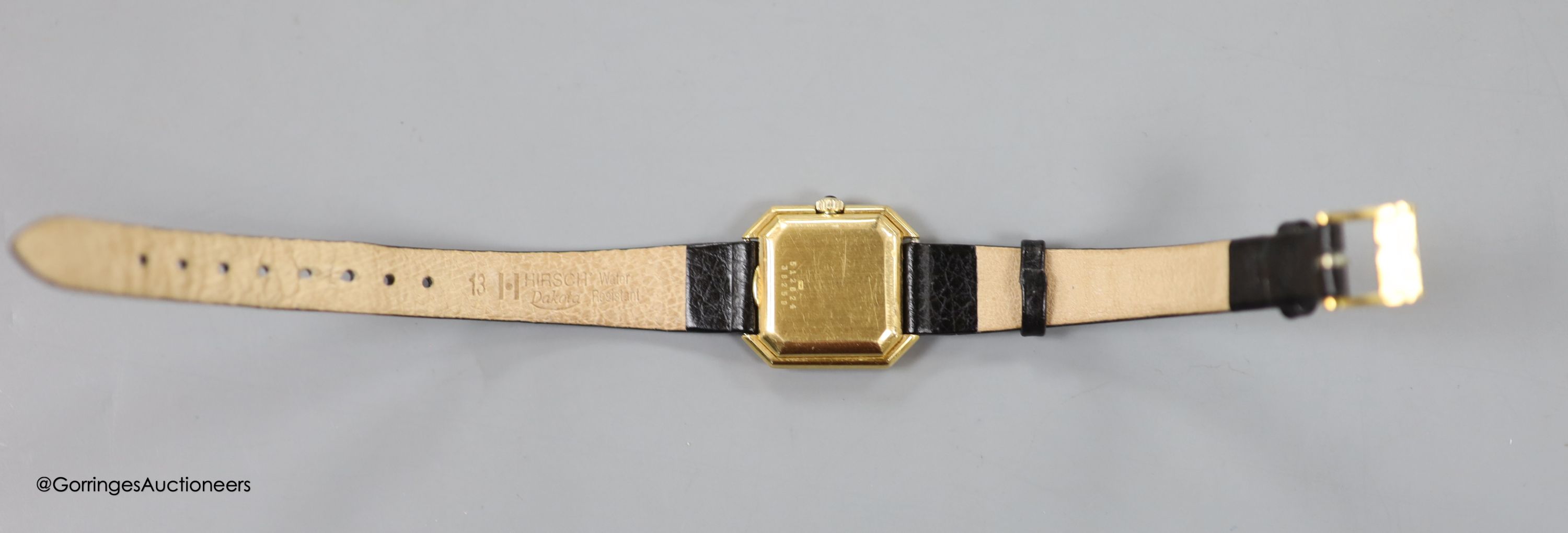 A lady's 18ct gold Baume & Mercier manual wing octagonal dial wrist watch, on associated leather strap